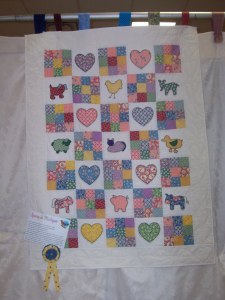 Farm Animal baby quilt displayed at the MMQG Spring in Michigan quilt show.